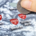 Close-up of a poster with the word 'Rescue' partially visible and a red circular marker reading '2503 m' on a snowy blue background.